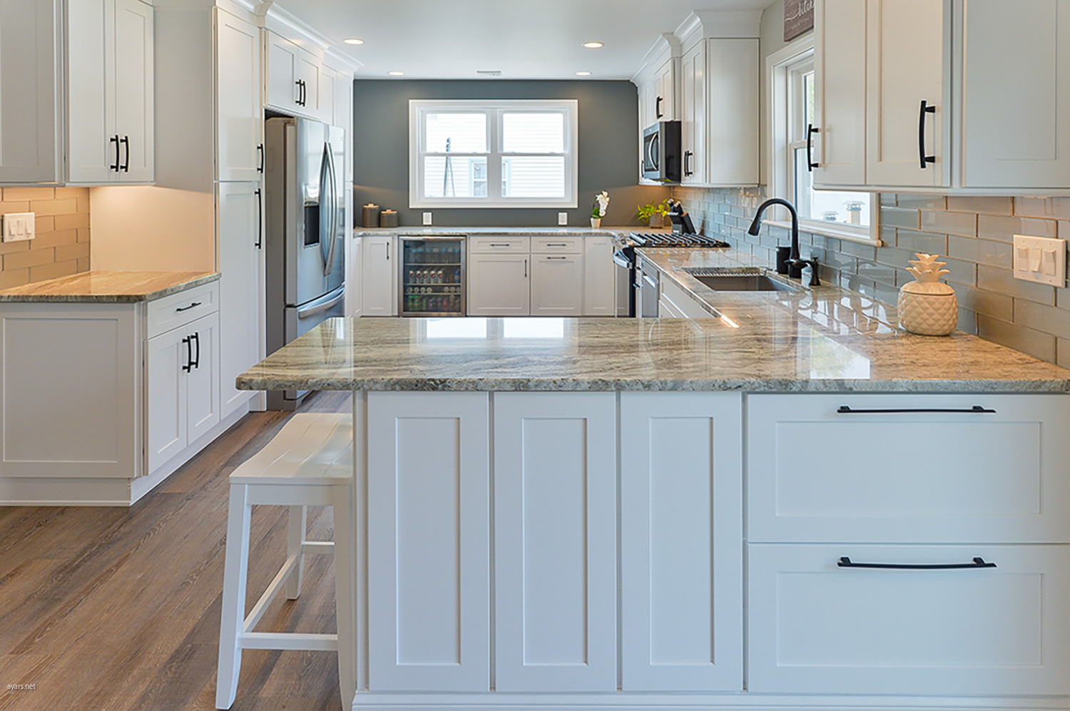 Sleek kitchen remodel, white cabinets, natural lighting